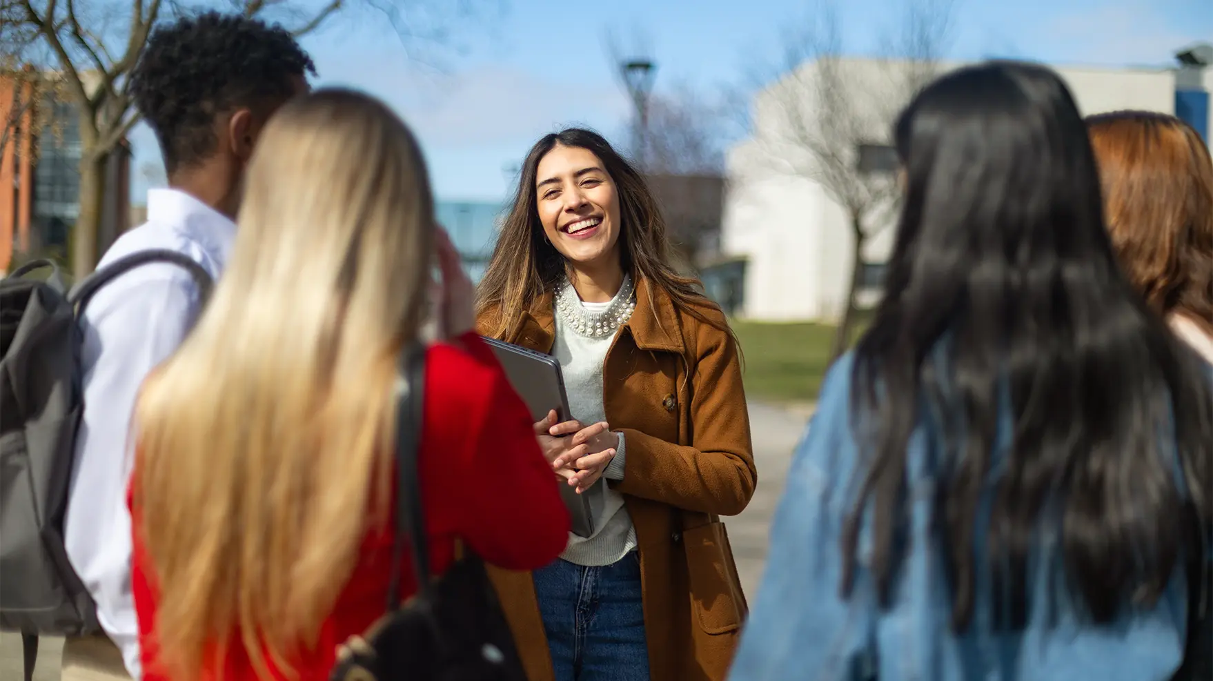 young professional engaging in a discussion with her peers