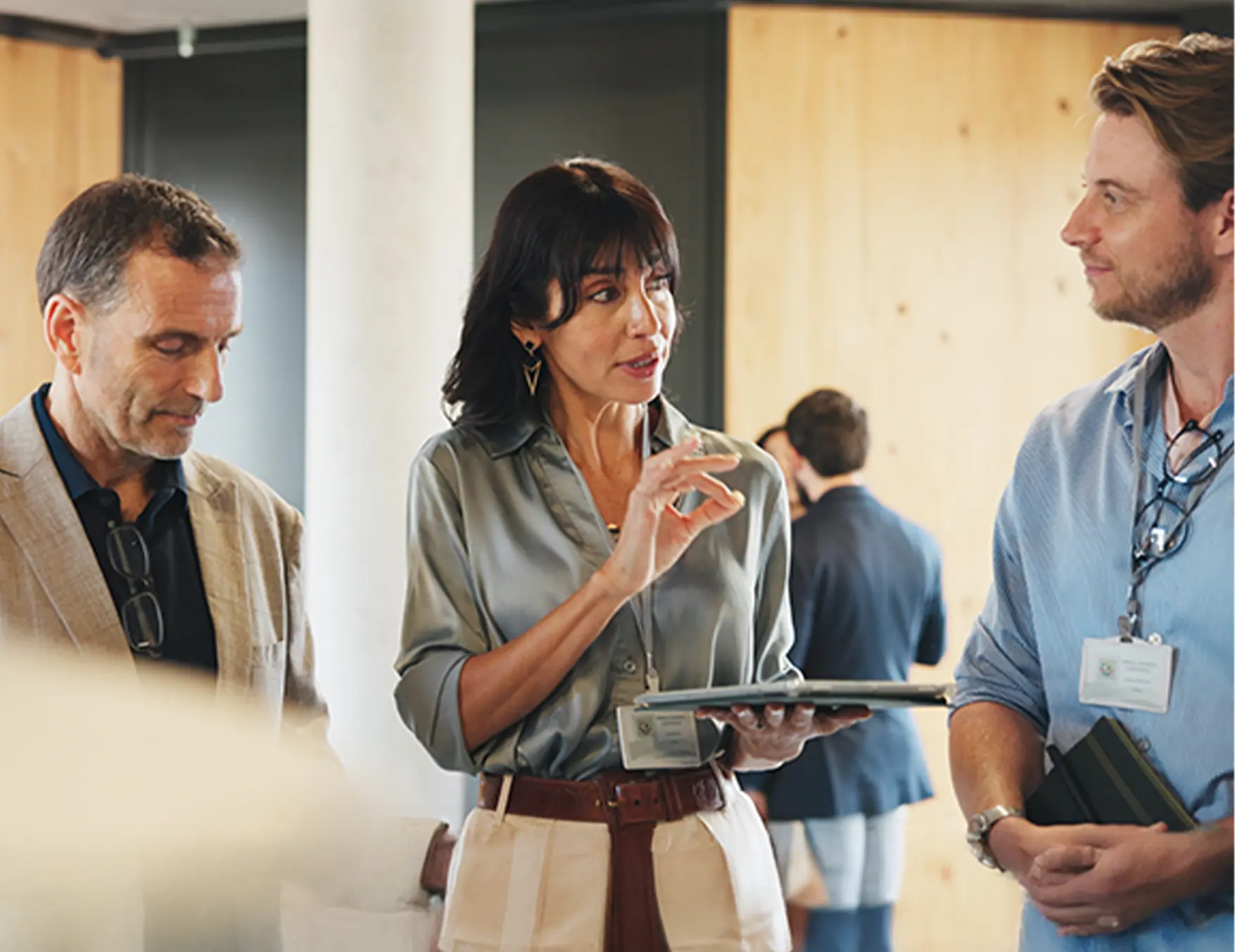 woman pointing out business information to her colleagues in a casual discussion