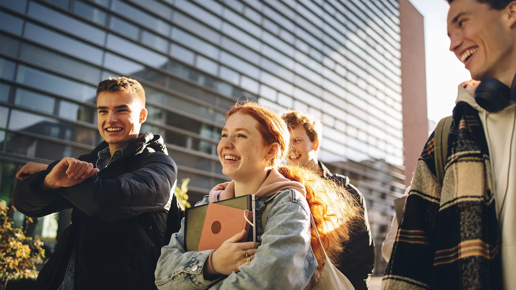 group of students smiling and walking outside